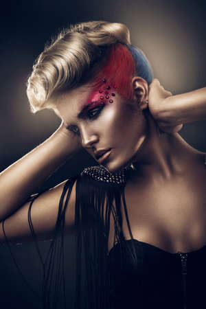 blonde woman with colourful make-upの写真素材