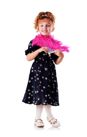 Little stands and smiles girl with fan in black dress with stars on white backgroundの写真素材