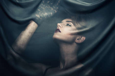 woman in gloves through fabricの写真素材