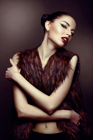 close-up portrait of a beautiful girl in a fur coatの写真素材