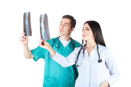 doctors looking at radiograph on white backgroundの写真素材