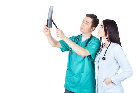 professional doctors looking at radiograph on white backgroundの写真素材