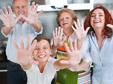 Grandparents, parents and children baking in the kitchenの写真素材