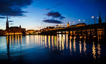view of the city of Stockholm with water reflection on duskの写真素材