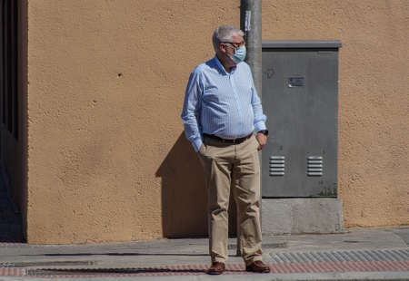 Madrid / Spain - 06/18/2020: Retired man on the street. New situation in Spain about the pandemic of Covid-19. People are using mask in their new life routine.のeditorial素材