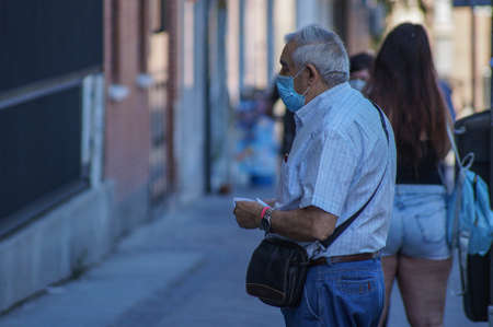 Madrid / Spain - 06/18/2020: Retired man on the street. New situation in Spain about the pandemic of Covid-19. People are using mask in their new life routine.のeditorial素材