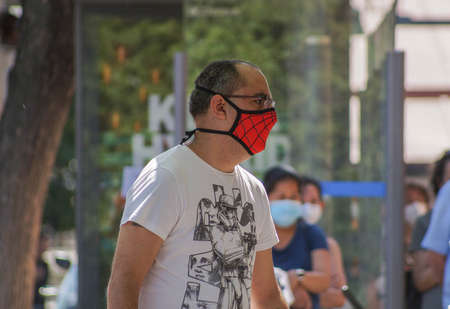 Madrid / Spain - 07 13 20: A man with original Spiderman face mask during the pandemic of Covid-19 in the street of Madrid in the summerのeditorial素材