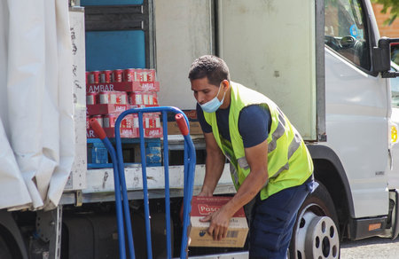 Madrid / Spain - 07 13 20: A worker in the summer is using a face mask during the pandemic