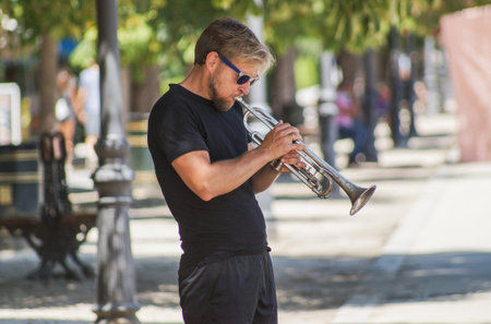 Madrid / Spain - 07 23 20: musician is playing his trumpet at Retiro park at summerのeditorial素材