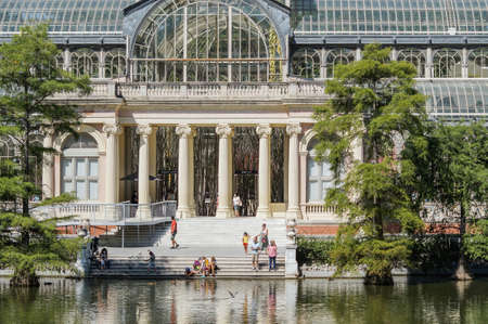Madrid / Spain - 07 23 20: people on the main door of Glass Palace at Retiro park in the summer, with close-up view of the lake.のeditorial素材