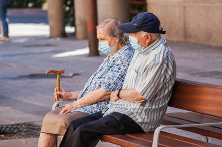 Madrid, Spain / 08 19 20: Coronavirus crisis in Madrid. Retired couple on a bench.のeditorial素材