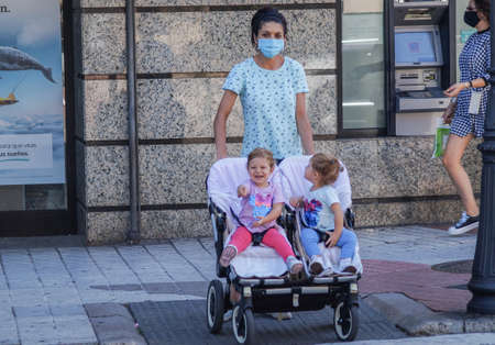 Caceres, Extremadura / Spain - 08 22 2020: mum with two kids on the streetのeditorial素材
