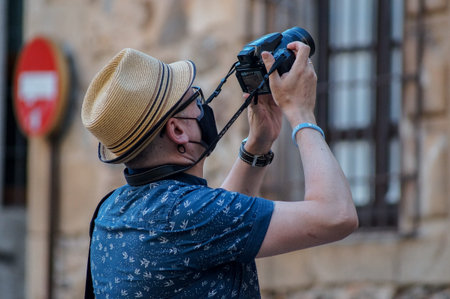 Caceres, Extremadura / Spain - 08 22 2020: A tourist is taken a picture with his cameraのeditorial素材