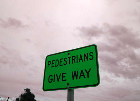 Unusual, pedestrians give way green signの写真素材