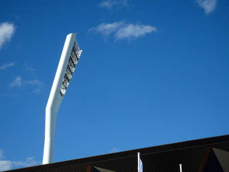 Giant futuristic modern, white  tower with stadium lightsの写真素材