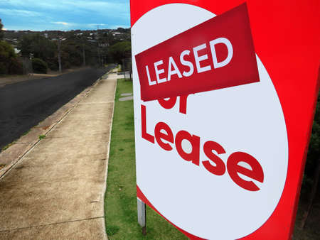 House for lease sign in front of a home with the leased stickerの写真素材