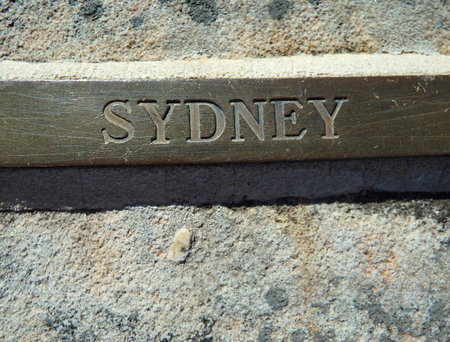 Sydney engraved in bronze tag in historical stone wallの写真素材