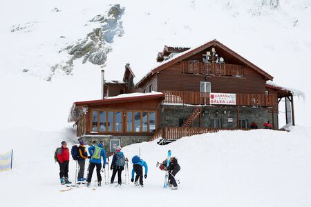 Skiers stop at the entrance of the cabinのeditorial素材
