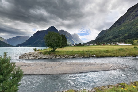Scenic view of mountains, lake and river at Geiranger Fjord area (Norway)の写真素材