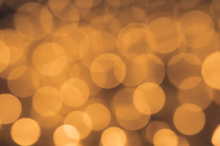 Christmas lights out of focus only on bokeh. Golden circles. Abstract background.の写真素材