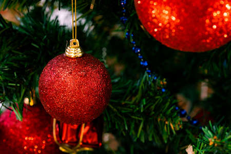 Red glittering christmas balls. Christmas baubles on christmas tree. Macro photo. Christmas vibe.の写真素材