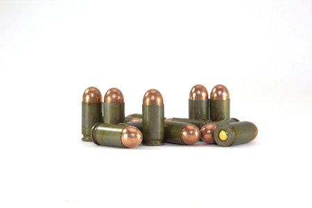 Cartridges with shell bullets for Makarov pistol on white background close-up