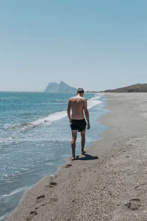 White man enjoying sunny day at beachの写真素材