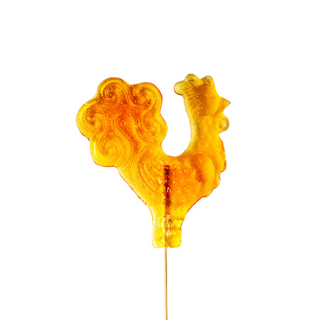 Sugar cockerel on a stick  Isolated on white background の写真素材