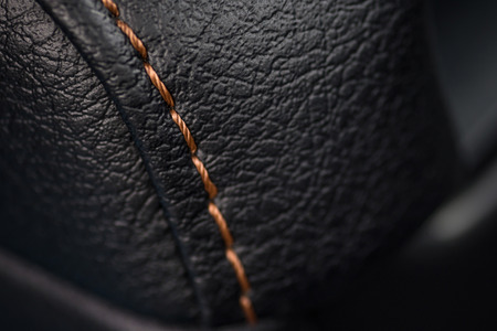 Car leather texture with stitch. Interior detail. Macro photo.の写真素材
