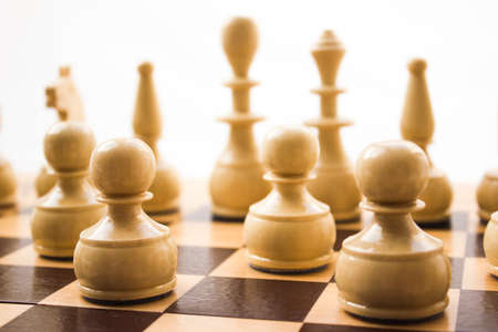 Chess pieces on a board in different compositions.の写真素材