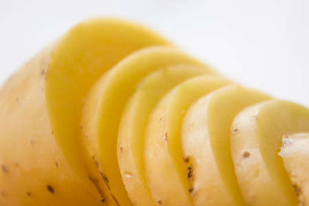 Sliced potato on a wooden cutting board.の写真素材