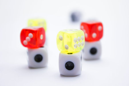 Composition from different colored dices on a white background.