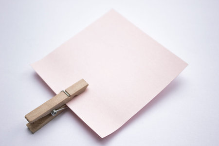A reminder note pinned with a wooden peg on the side.の写真素材