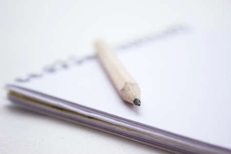 Pencil in a composition with a blank book with hardcovers.の写真素材