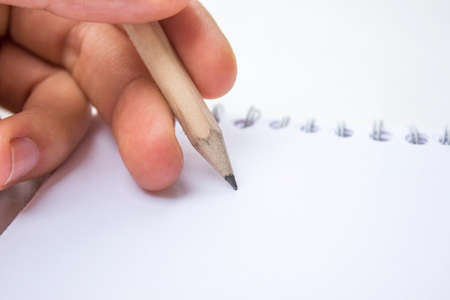 Pencil in a composition with a blank bookの写真素材