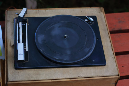 wet, old record player on a bench