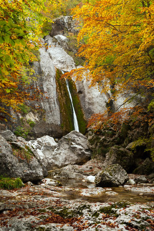 Italy, Abruzzo national park, waterfall between the rocks in autumnの写真素材