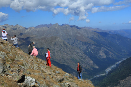 People rising on a slope on mountain top