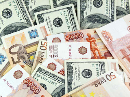 Heap from dollars of the Russian roubles and euroの写真素材