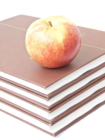 Isolated apple on a stack of four booksの写真素材