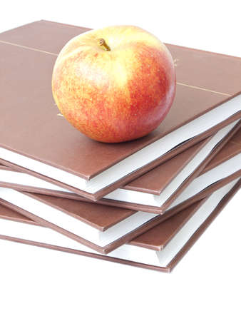 Isolated apple on a stack of four booksの写真素材