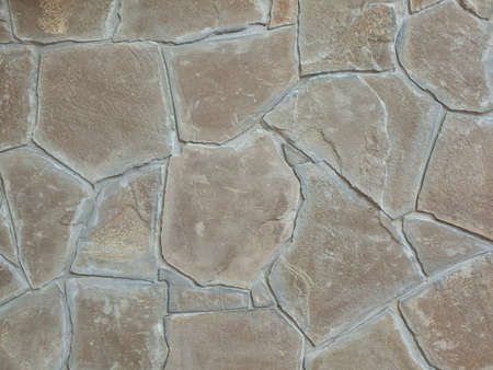 Background and texture from a wall trimmed with a stoneの写真素材