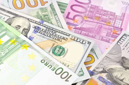 Stack of euro and new dollar banknotes in soft focusの写真素材