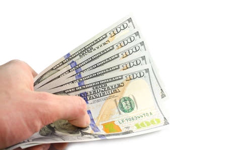 A stack of new USA cash, isolated on white background with soft focusing on a handの写真素材