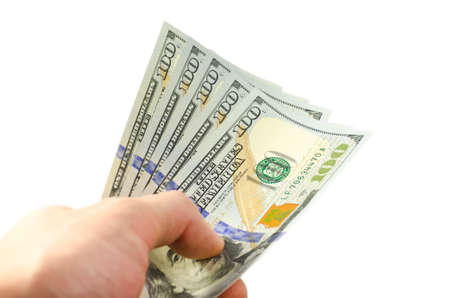 A stack of new USA cash, isolated on white background with soft focusing on a handの写真素材