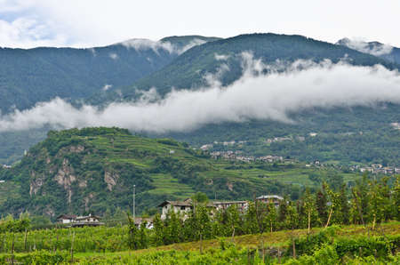 Low rain clouds over the Alps in Italyの写真素材