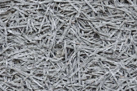 Background of gray insulation from the grass with soft focusの写真素材