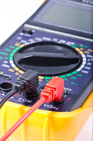 Modern digital multimeter on a white background, shallow depth of field