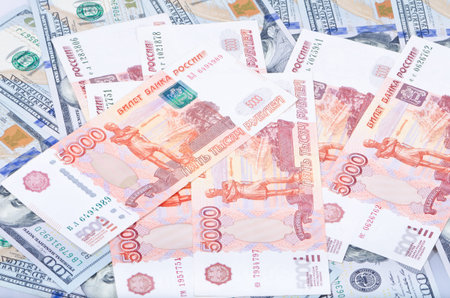 The background of Russian rubles and U.S. dollars