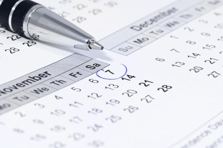 Blue circle marked on a calendar, reminder about an important date, shallow depth of fieldの写真素材